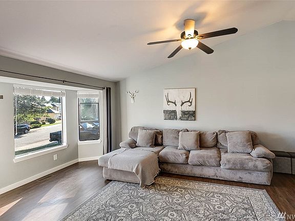 Soaring vaulted ceilings, gleaming floors and designer colors make this gorgeous home move-in ready! The formal living room is further enhanced with bay windows.