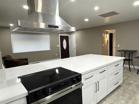 The home now has an open concept, with this stunning large kitchen island open to the great room. The boasts new cabinets with soft close drawers and doors and quartz countertops.