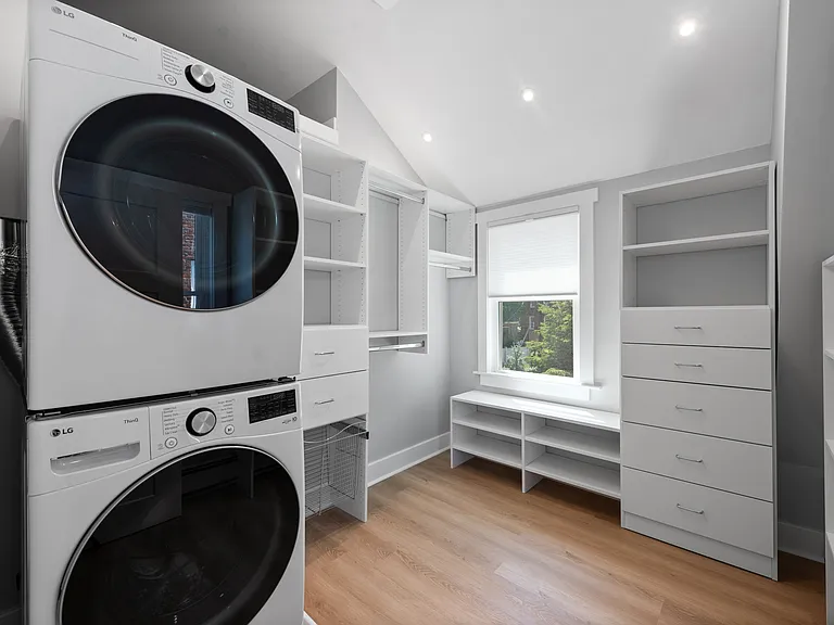 Upstairs washer and dryer located in walk-in closet adjacent to bedroom.