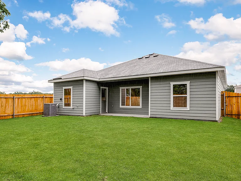 The back yard is fully fenced-in.