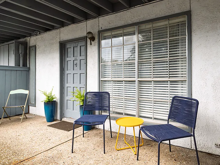 Step outside to a private patio with casual seating_an inviting spot to relax, get some fresh air, or enjoy a quiet moment outdoors.
