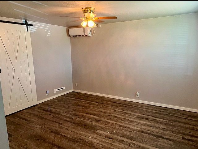 Living Room with barn door separating living room from the bedroom.