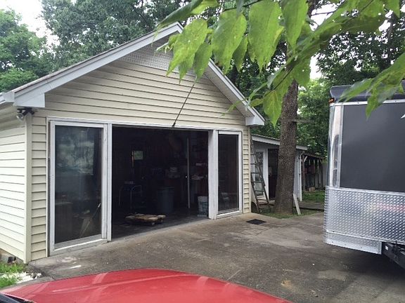 Garage and workshop in back . Backyard fenced
