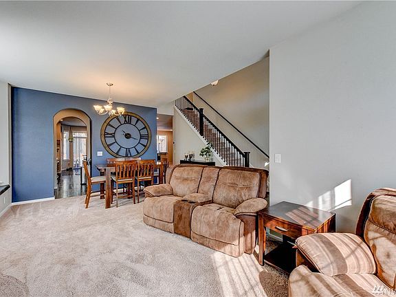 Front living Room with Bay window and dining area showing Butlers pantry into Kitchen and Great room in Background.