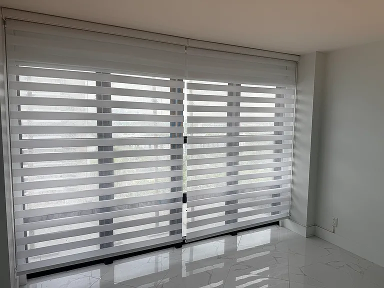 MASTER BEDROOM with dimmable designer lighting, full wall mirror, floor-to-ceiling impact windows, electric blackout curtain, zebra shades, brand new walk-in closet & a second large closet