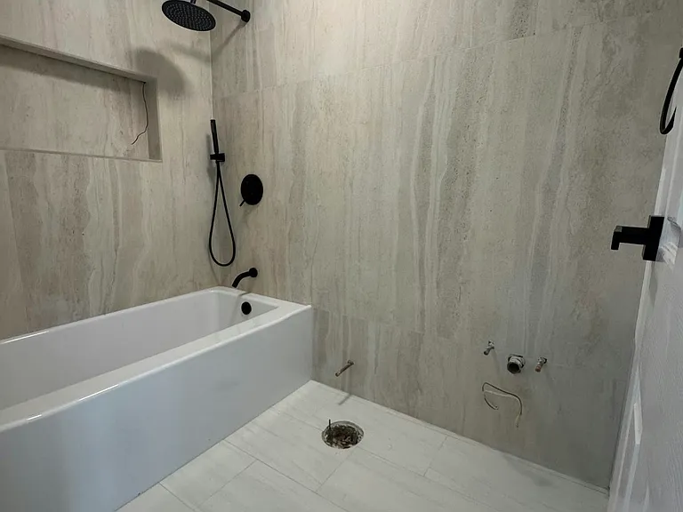 Newly remodeled bathroom. Missing shower door, vanity and mirror