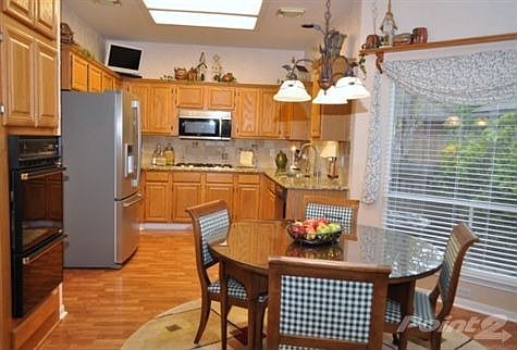 THis open and efficient kitchen design offers solid oak cabinets and new granite counters. View from