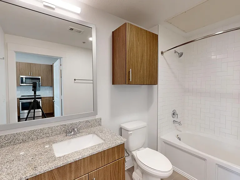 Apartment bathroom with tile flooring.