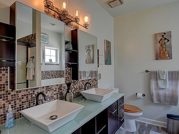 Master Bath with Dual Vanities and Ceramic Backsplash.