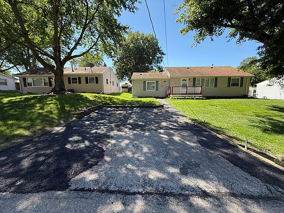 Expanded front driveway and more parking in the back alley with double garage
