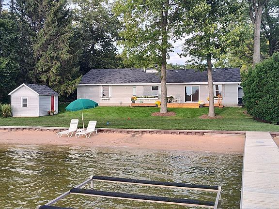 Lake side of house. House includes use of dock. Trees provide shade and privacy. 100 feet of beach