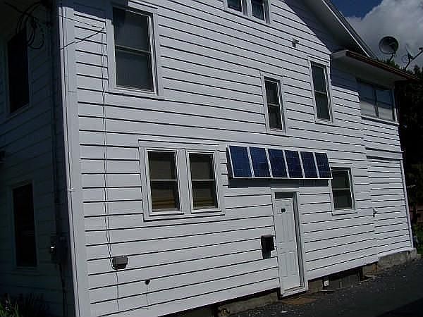 Driveway side w/ solar panels.