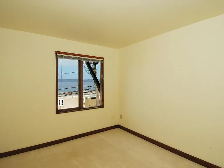 Not the greatest photo of master bedroom, but it also has a very large closet, and access to the full bath. West facing view.