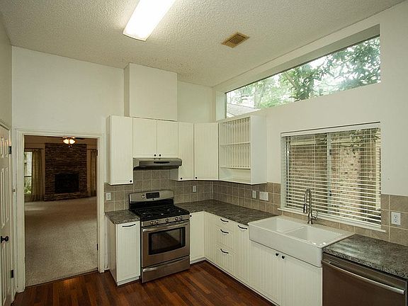 with white cabinetry, stainless appliances,