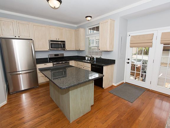 Kitchen with direct access to reserved parking. Washer and Dryer in adjacent pantry / closet.