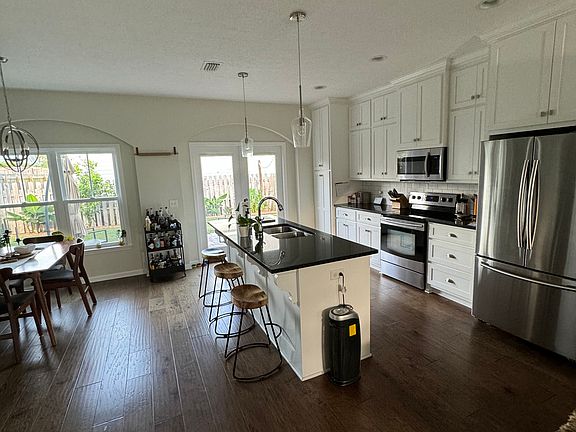 Open concept kitchen and dining area. Stainless steel appliances and plenty of storage. Counter top with a bar. Easy access to the backyard. Perfect for entertaining!