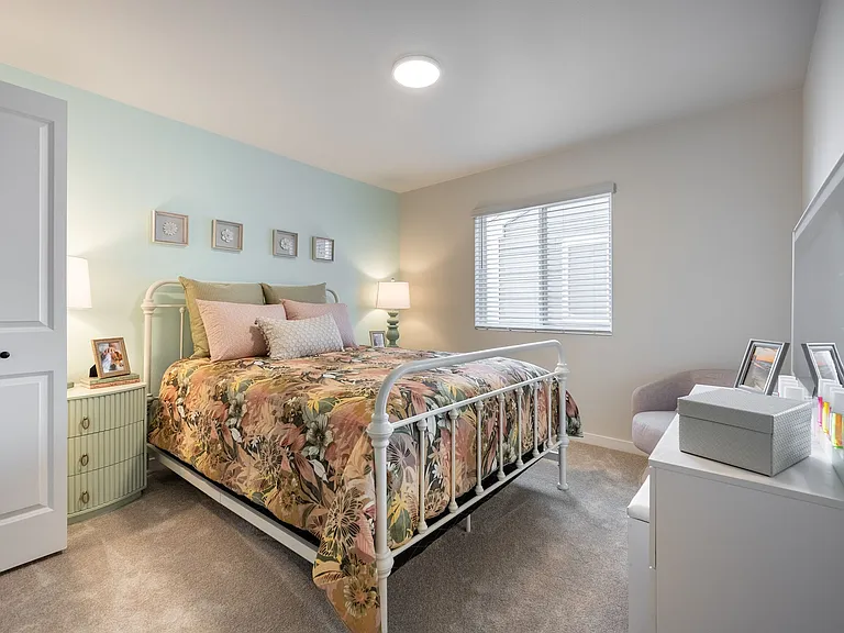 This spacious bedroom offers a peaceful retreat with a modern layout and calming vibes.