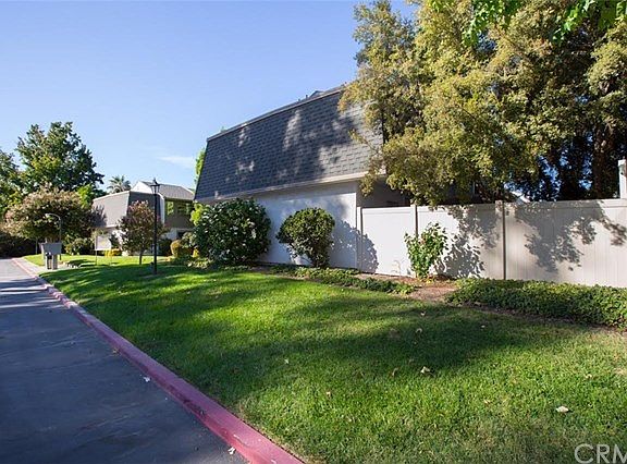 Exterior side showcasing privately fenced patio.