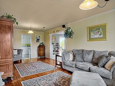 Traditional hardwood floors greet you as you enter the large lving room with h