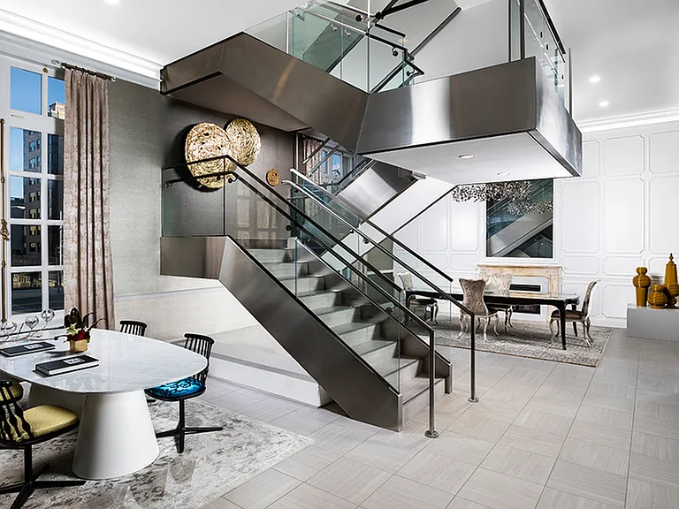 Modern touches mix with historical elements seamlessly at Modera Sedici, like this steel and glass staircase in the leasing area