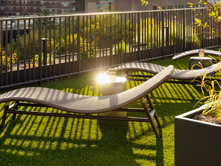 Unwind in style at Mabel, where serene outdoor spaces invite relaxation. Enjoy sun-drenched lounge chairs and lush landscaping, perfect for your leisure moments. Explore the tranquility that awaits you today!