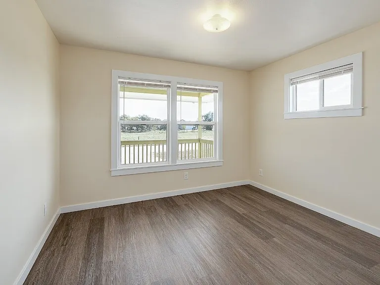 Front bedroom with large window looking onto the porch.