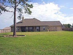 The rear of the home has a completely fenced backyard, with a 3 car garage.  