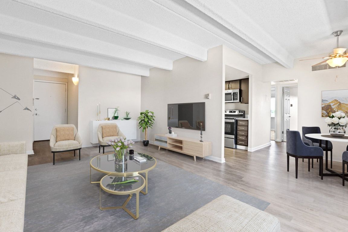 Spacious living area with exposed beams and modern flair