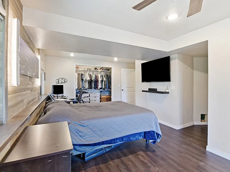 Spacious primary bedroom featuring a large walk-in IKEA closet, mounted TV, and plenty of room to relax after a day of hiking, skiing, or working from home."