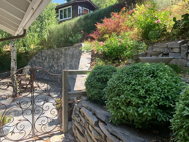 Gate to backyard patio with view of Cottage