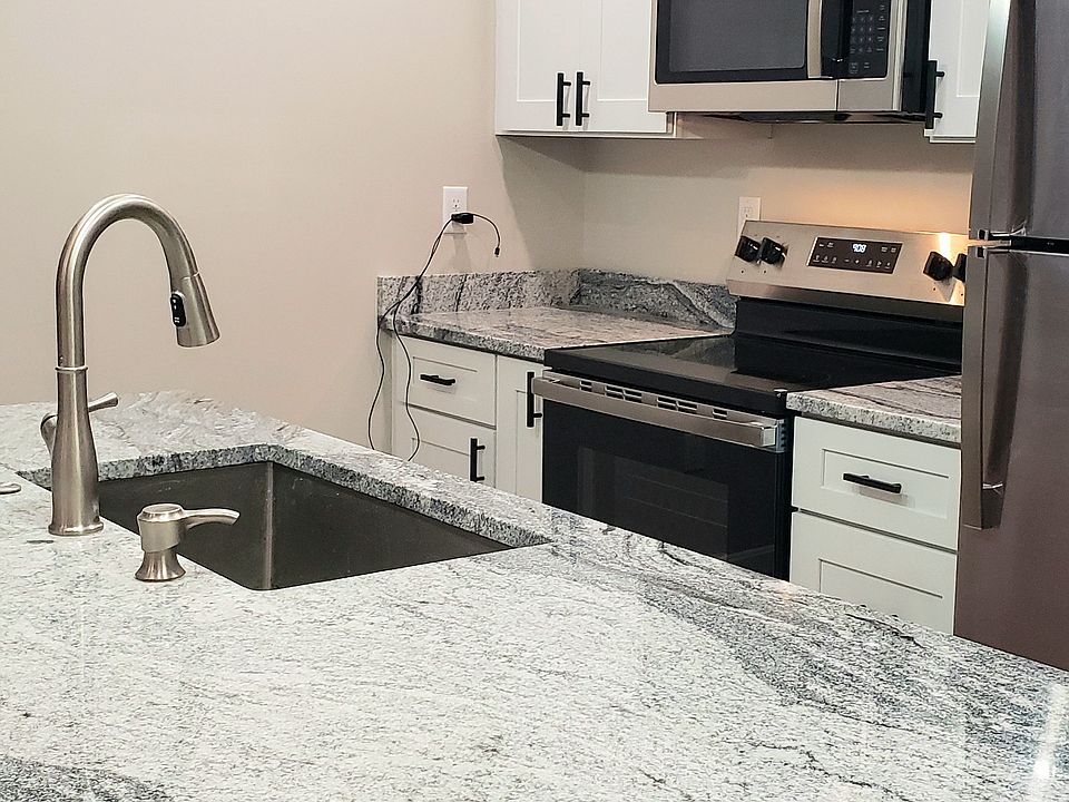 Open kitchen with island big enough to accommodate 4 bar stools. Equipped with all new stainless steel appliances and granite counter tops.