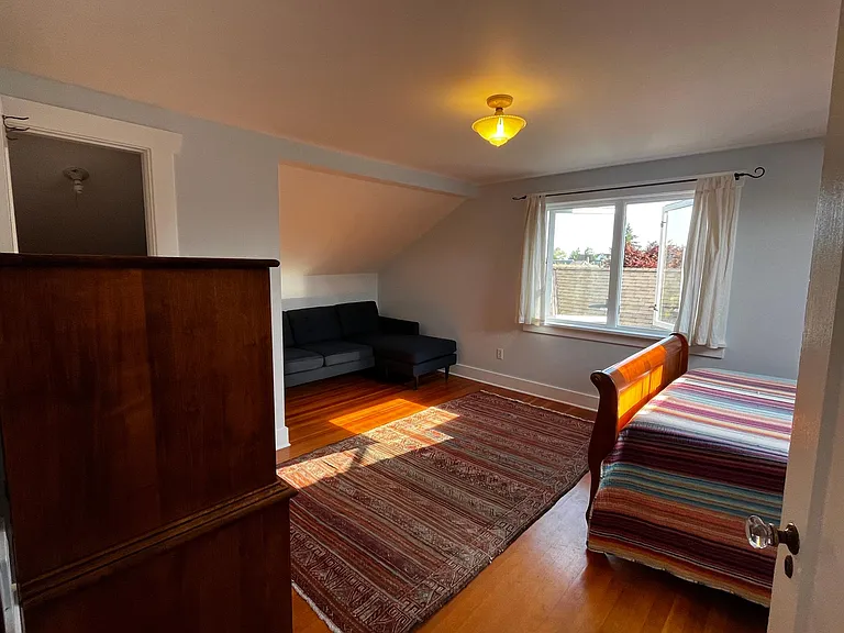 Second of two bedrooms on the top floor. Fir floors and period lighting. Casement windows.