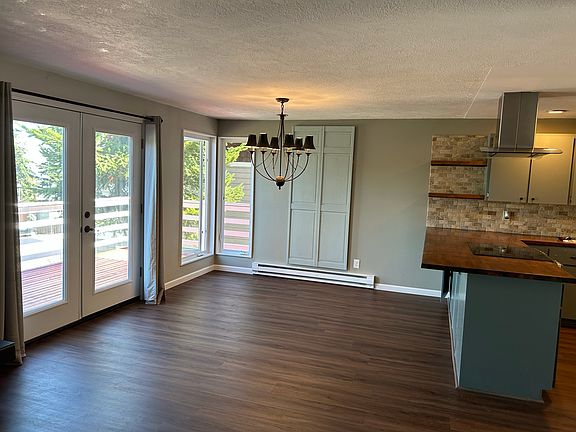 Kitchen opens to eating area and French door accessing wrap around deck.