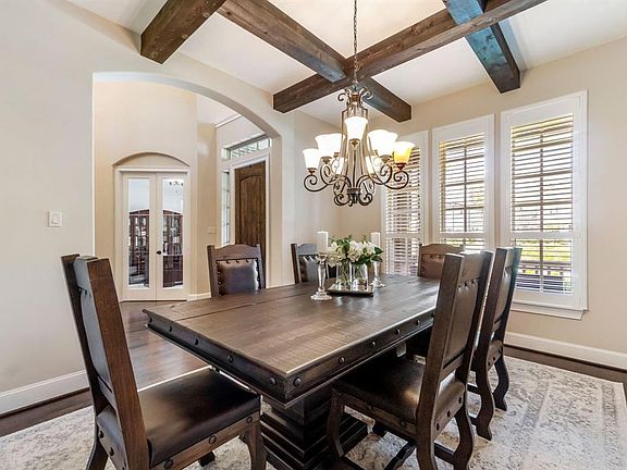Rich wood beams add architectural detail to this spacious dining room.