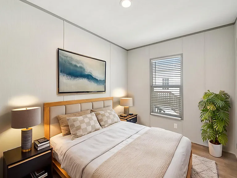 Cozy secondary bedroom with natural light, and a comfortable, inviting feel.