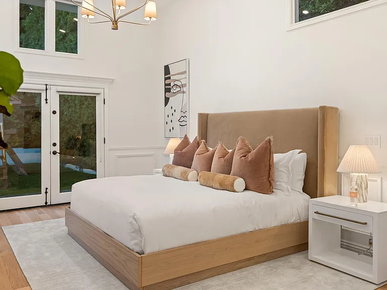 Extend your relaxation to the outdoors with French doors in Bedroom 1, seamlessly connecting your haven to the serene backyard.
