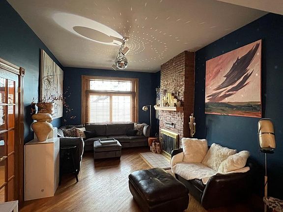 Cozy living room with working gas fireplace. It opens into the dinning room, as one big room
