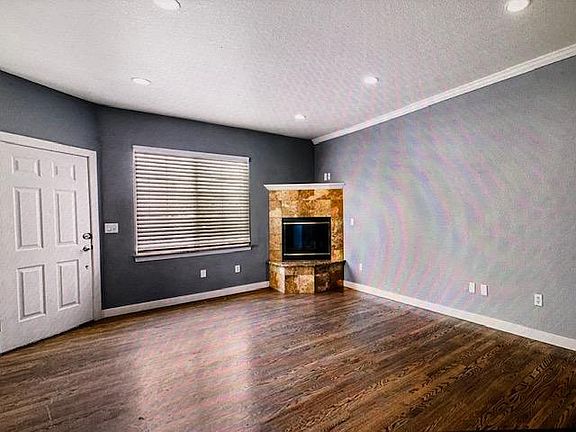 Working gas fireplace in living room, wood floors.