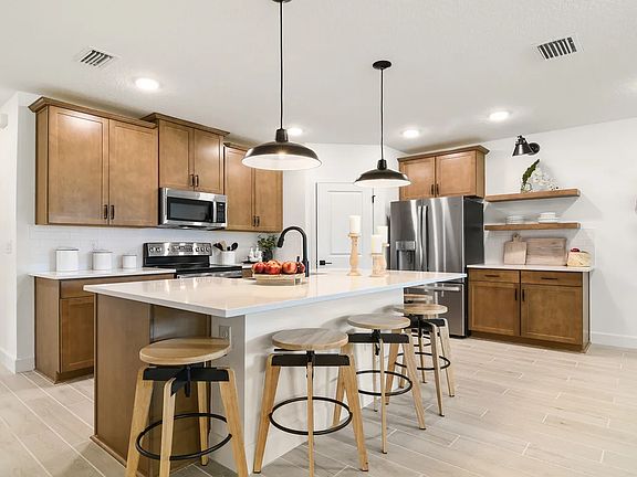 Kitchen with pendant lighting and floating shelves
