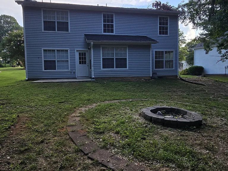Back of home with fire pit