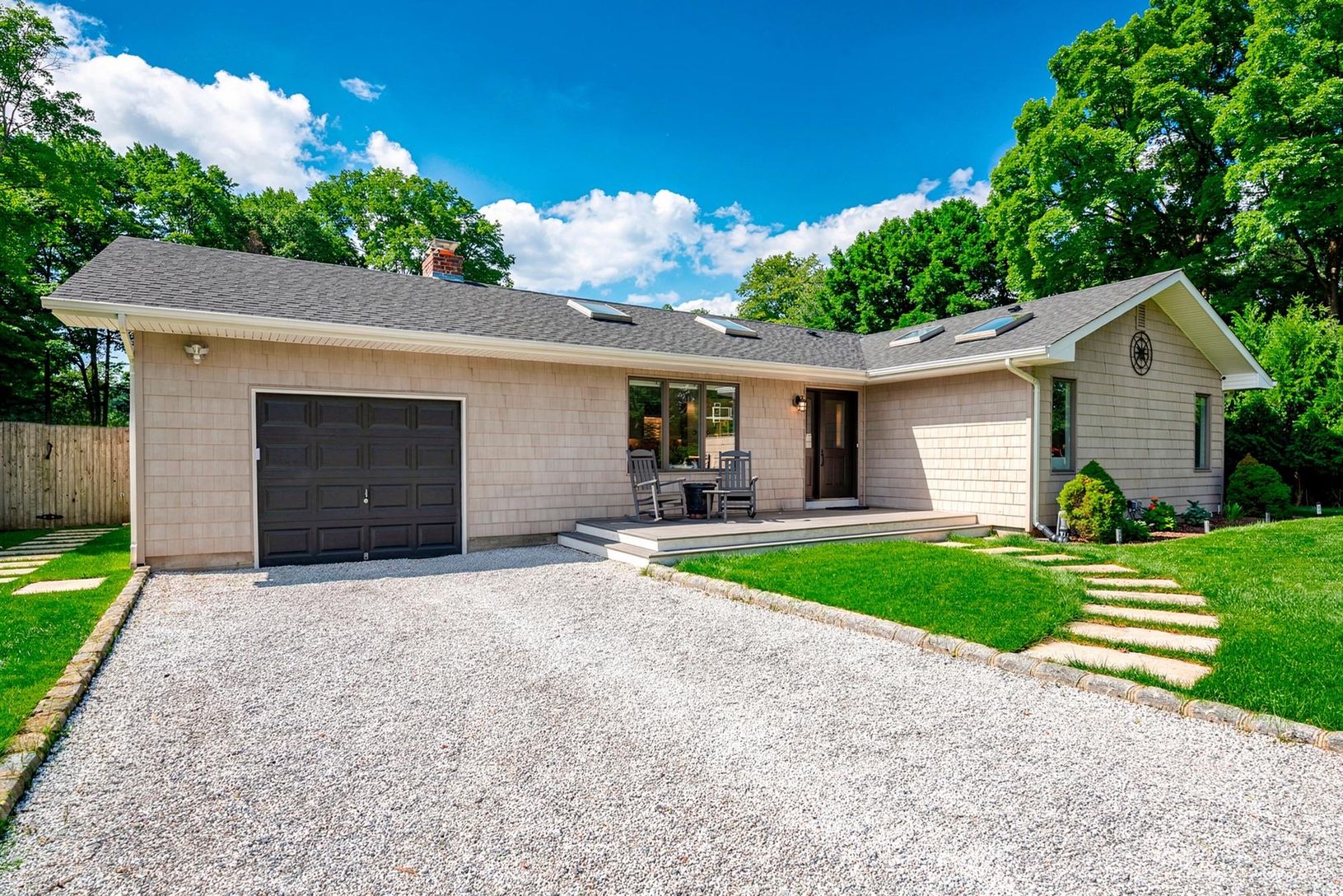  Front view close up of this charming turnkey single level on its private shy half acre. 
