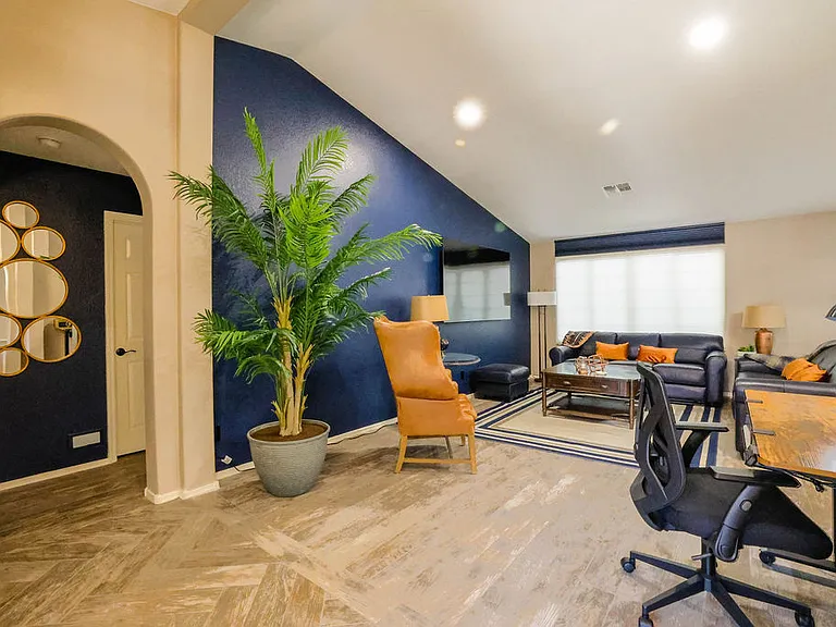 Open plan living room, dining room, kitchen, entry way.
Living room has 2 leather couches with queen size hide away bed, dining table seats 10, sliding door to patio seating