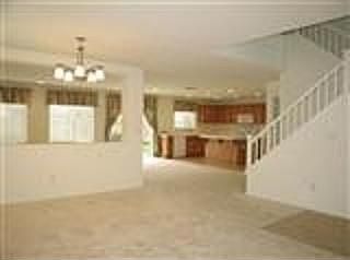view from the familyroom/dinning room looking at the stairway and kitchen.