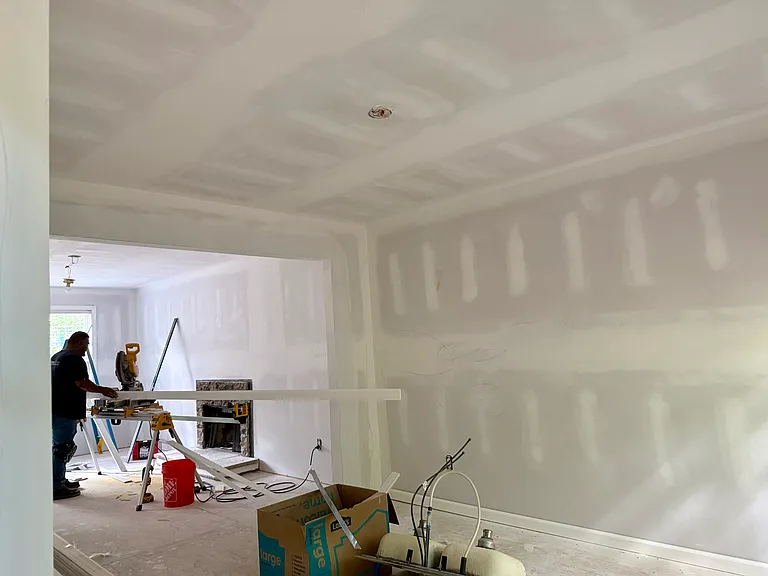 Dining room and view into the living room. Professional renovators are working hard to make this a beautiful rental.