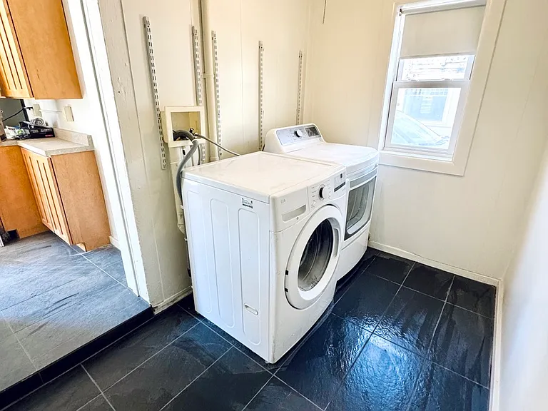 Laundry room / mud room just off the kitchen with washer and dryer.