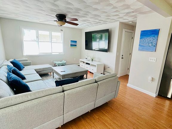 Large couch and giant flatscreen make this living room the perfect spot for game or movie nights. Brand new cozy pillows and blankets.