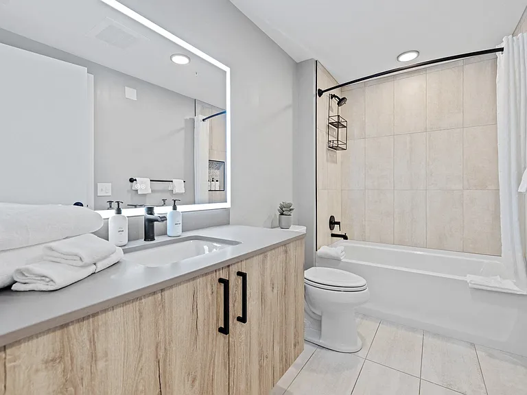 Large bathroom with modern finishes and plenty of storage.