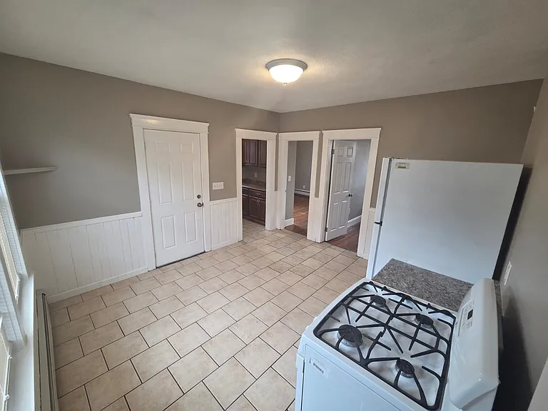 Kitchen Stove Fridge and Dining area