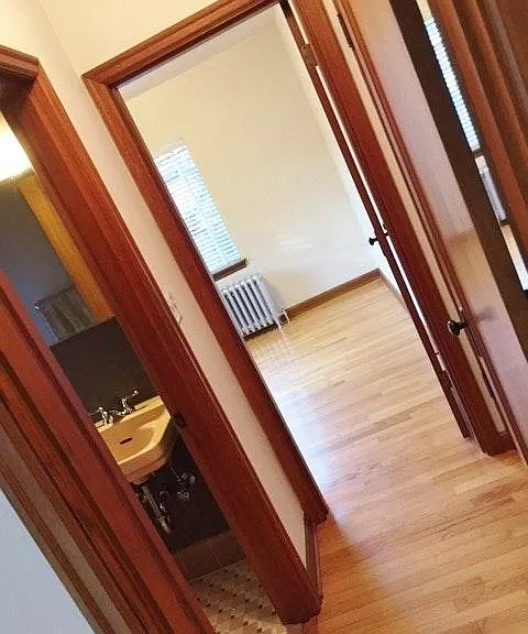 Hallway with bathroom, linen closet (not seen) on right.