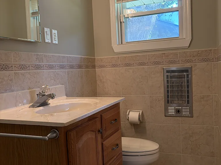Secondary bedroom with its own private full bathroom, offering added comfort and convenience for guests or family members.
